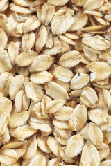 Close up picture of thick rolled oats, selective focus.