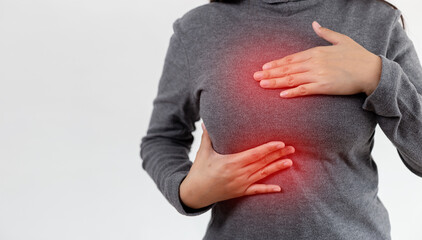 Close-up Woman hand touching her breast screening by self. female checks lump in her breast with...
