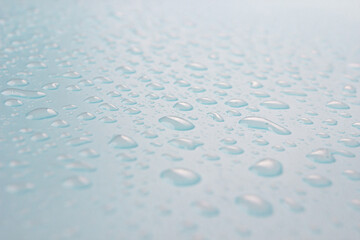 Close up of dropped water on a blue background. Freshness, raindrop