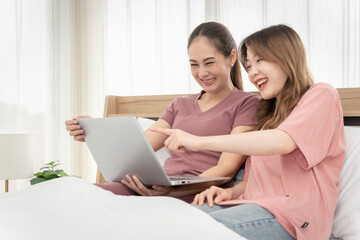 Asian woman sitting at home working in the bedroom take notes of the meeting Record work with a notebook. Cheerful, fun at work.