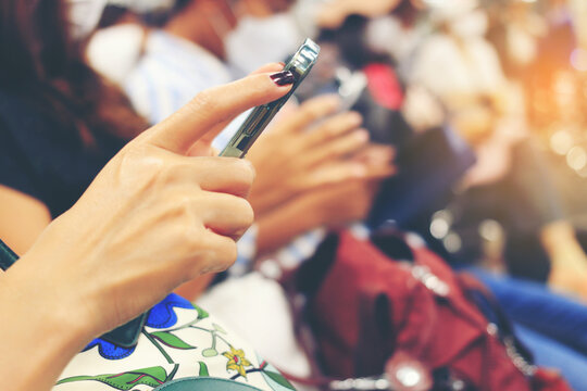 Hand of woman text message on smart phone or technology. Girl using cellphone on building castle background close. Tourist female hands holding gadget on blurred airport background.