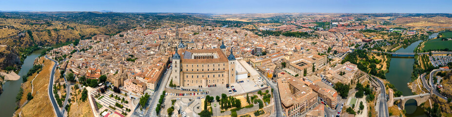 A panoramic aerial view of Toledo with the Alcazar fortress and Tagus River - obrazy, fototapety, plakaty