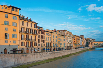 Naklejka na ściany i meble The Ponte Vecchio, Old Bridge, is a Medieval stone closed-spandrel segmental arch bridge over the Arno River, with shops built along it; as jewelers, art dealers and souvenir sellers. Italy, 2019