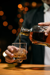 Barman pouring whiskey whiskey glass beautiful night