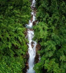 beautiful nature landscape krating waterfall and small photographer in the rainy season and...