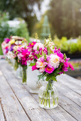 Dahlia bouquets outdoors on a wooden table