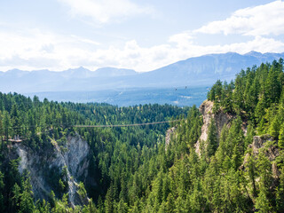 view of suspension bridge in the rocky mountains of canada