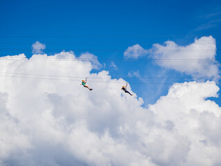zip lining across the clouds