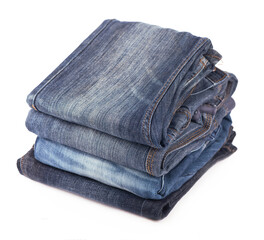 Stack of blue jeans on a white background