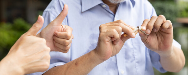 Header crop of old senior man quit smoking, getting approving thumb up for his dedication