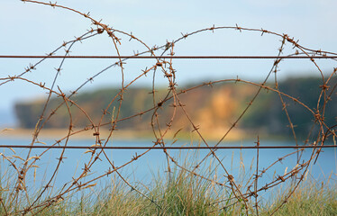 barbed wire of World War II protection in the Normandy landing beaches.