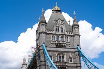 Fototapeta na wymiar Tower Bridge Tower closeup with puffy clouds behind