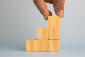 hand holding cube wood block blank on background. copy space