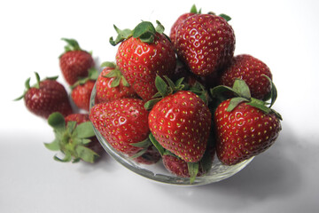 Fresh strawberries in a transparent glass bowl