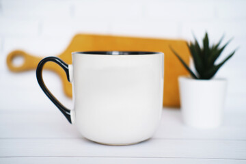 White  mug mockup for presentation sublimation designs, cup with copy space on front in lifestyle setting
