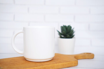 White  mug mockup for presentation sublimation designs, cup with copy space on front in lifestyle setting