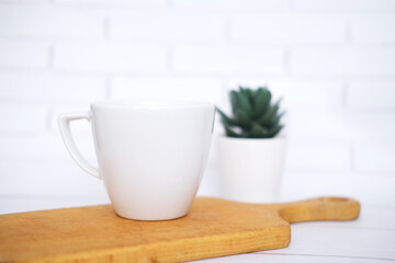 White  mug mockup for presentation sublimation designs, cup with copy space on front in lifestyle setting