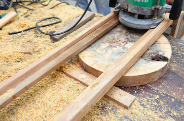 Young man doing woodworking hobby in his workshop, soft focus.