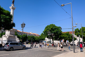 Fototapeta na wymiar People walking nearby Rossio square in Lisbon 