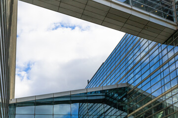 Fototapeta na wymiar Modern glass building with blue sky and clouds reflection. High quality photo