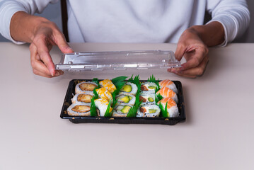 person opening sushi tray, delivery, fast food