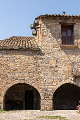 Fototapeta na wymiar Strolling through the narrow cobbled street at Ainsa village, Aragon, Spain
