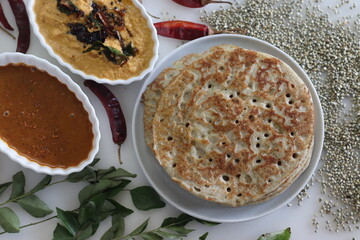 Soft Bajra Dosa. Soft and spongy pancakes made of fermented batter of pearl millet and lentils. Served with spicy coconut condiment and lentil vegetable soup