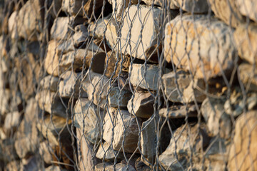 metal mesh on a stone wall. slope crumbling protection