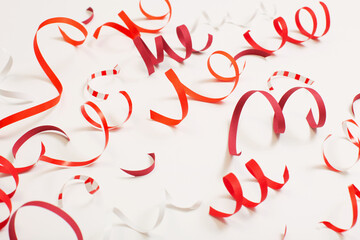 birthday background with red serpentine on white