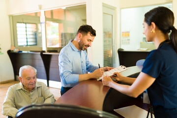 Smiling man asking admission information at the retirement home
