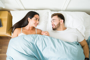 Fototapeta na wymiar Loving couple having a romantic moment while sleeping in bed