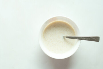 healthy breakfast with oats flakes and banana on table , top down 