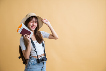 young attractive Asian woman traveler in casual clothes wearing straw hat with backpack, passport, camera and boarding pass ticket, Tourist girl having cheerful holiday trip concept