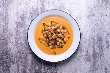 Salmorejo with chickpeas and ham. Typical Spanish cold soup recipe made with tomatoes and vegetables. Traditional tapas from the south of Spain.