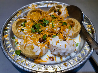 Doi Fuchka - famous and unique south asian food served on a silver plate. Fried panipuri with sweet...