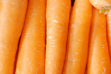 fresh carrots on chopping board on table 
