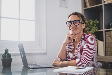 Portrait of beautiful woman smiling and talking to a man next to her talking about business work together in the office. Businesswoman working from home indoor..