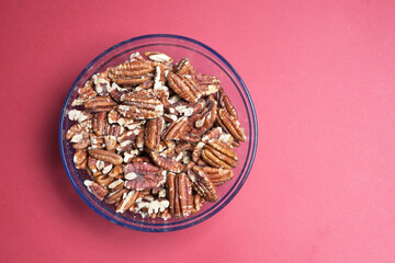 walnut in a bowl on red background 