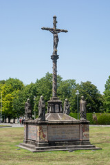 Fototapeta na wymiar Cross in Lourdes, France. Main facade of the Sanctuary,