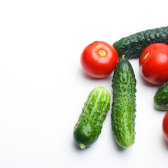 vegetables tomatoes and cucumbers on a white background studio photo
