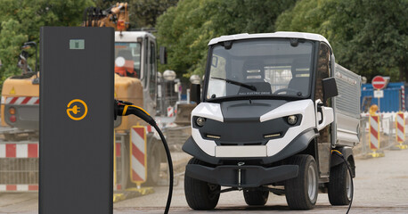 Urban electric truck with charging station at construction site