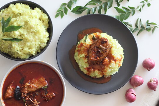 Mashed tapioca served with pomfret fish curry. Boiled and strained tapioca pieces mashed with spiced coconut taste best with fish curry prepared in Kerala style