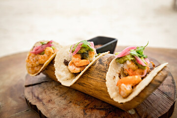 Traditional Mexican Prawn tacos close up, tacos on the beach in Mexico - obrazy, fototapety, plakaty