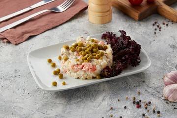 Russian traditional salad Olivier with vegetables and meat