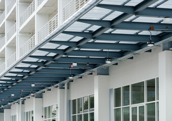 modern white building tranlucent light fiberglass roof with steel and concrete construction industrail style.