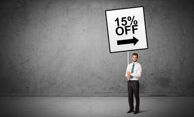 Fototapeta premium business person holding a traffic sign concept