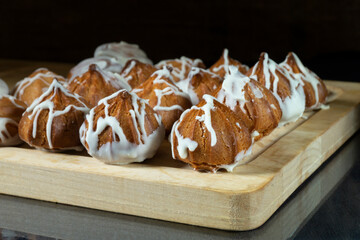 Custard cakes on a chopping board close-up
