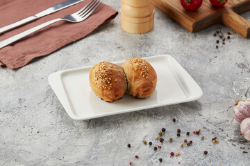 samsa - a bun with meat, with lamb meat on a plate