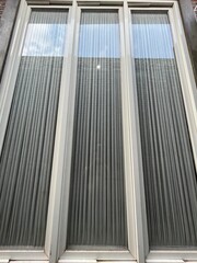 abstract wall texture. the concept of a house wall or fence for home decoration. Minimalist house made of bricks & sandstone. The walls are overgrown with plants, adding a natural & elegant impression