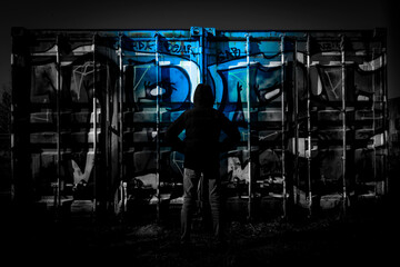 people at night in front of graffiti